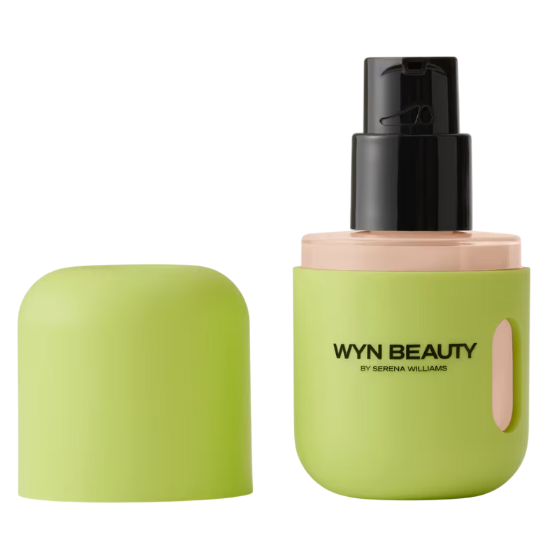 A lime green bottle with a black pump dispenser labeled \“WYN Beauty by Serena Williams.\“