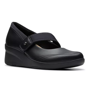 Black leather wedge shoes with a Mary Jane design, featuring a broad strap across the top for secure fastening and a comfortable cushioned sole. The shoes have a subtle stitch detail and a slightly elevated sole for added support.