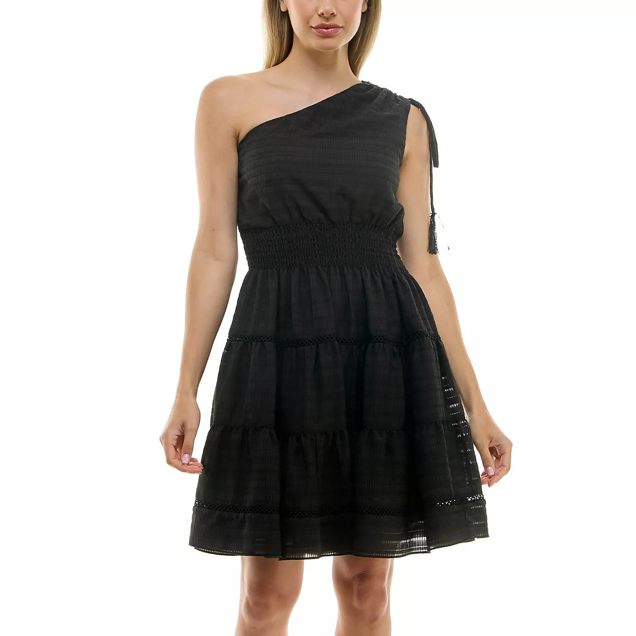 A black, one-shoulder dress with an elastic waistband and tiered skirt, featuring a shoulder tie detail and subtle horizontal texture.