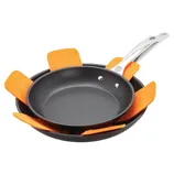 Two non-stick frying pans are shown with orange protective pads between them to prevent scratching when stacked.