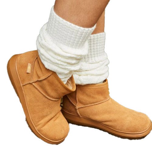 Tan suede ankle boots with soft white knit socks, featuring folded tops and a casual style.