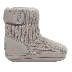 A gray UGG baby boot with a knit upper and soft sole, featuring a Velcro strap for easy fastening.