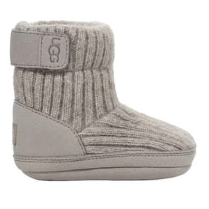 A gray UGG baby boot with a knit upper and soft sole, featuring a Velcro strap for easy fastening.