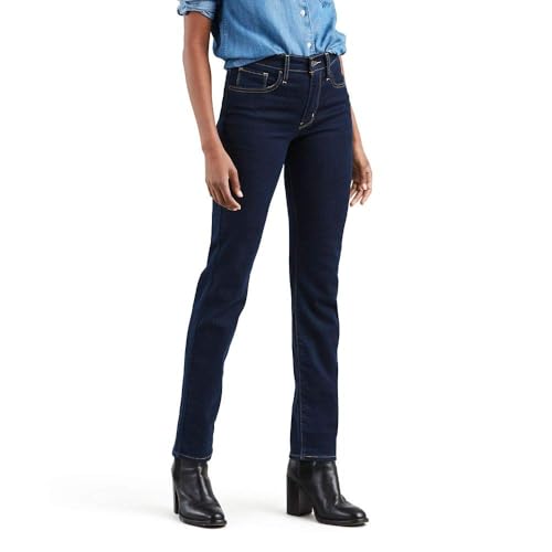 A person wears dark blue straight-leg jeans, paired with a light blue denim shirt and black heeled boots.