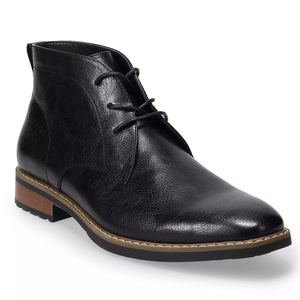 A black leather chukka boot with a textured finish, featuring black laces and a wooden sole with a contrast stitch detail.