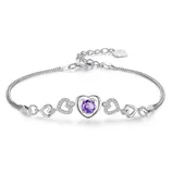 A silver bracelet featuring a central purple heart-shaped gemstone surrounded by hollow heart-shaped designs, some with embedded crystals.