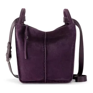 A purple suede crossbody bag with stitching details, an adjustable leather strap, and a simple, minimalist design.