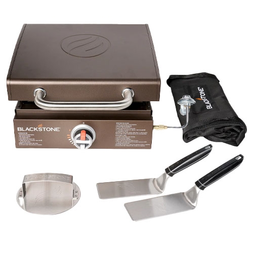 Blackstone 17\“ Griddle with a 12,500 BTU output includes a tool kit featuring two stainless steel spatulas, a protective griddle cover, and a grill carry bag for convenient transport.