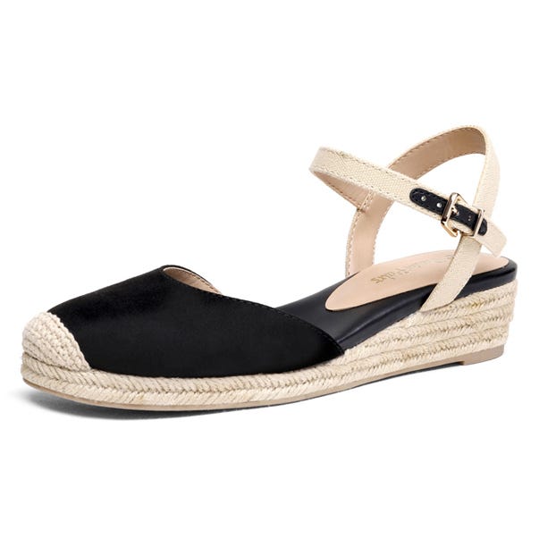A casual espadrille sandal with a black closed-toe, jute rope sole, and beige ankle strap featuring a buckle closure.