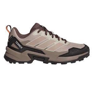 A beige and brown Adidas Terrex hiking shoe with a rugged sole and orange pull tab, designed for outdoor activities.