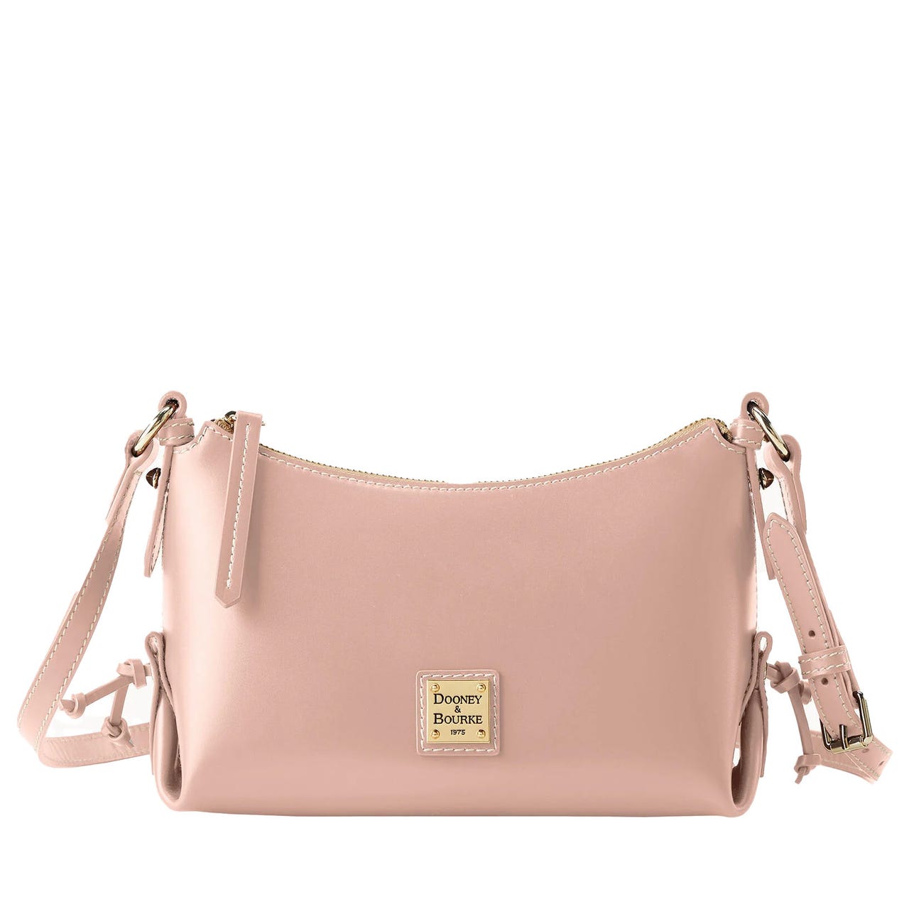 A blush pink Dooney & Bourke Penrose 2 Crossbody bag features a sleek, curved design with an adjustable strap, gold-tone hardware, and a zippered top closure.