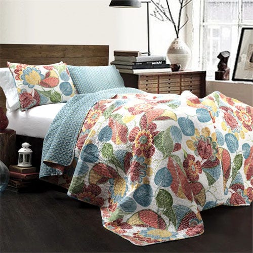 A blue and orange floral printed quilt set.