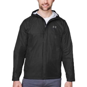A man wearing a black Under Armour hooded jacket with a front zipper and the brand logo on the chest.
