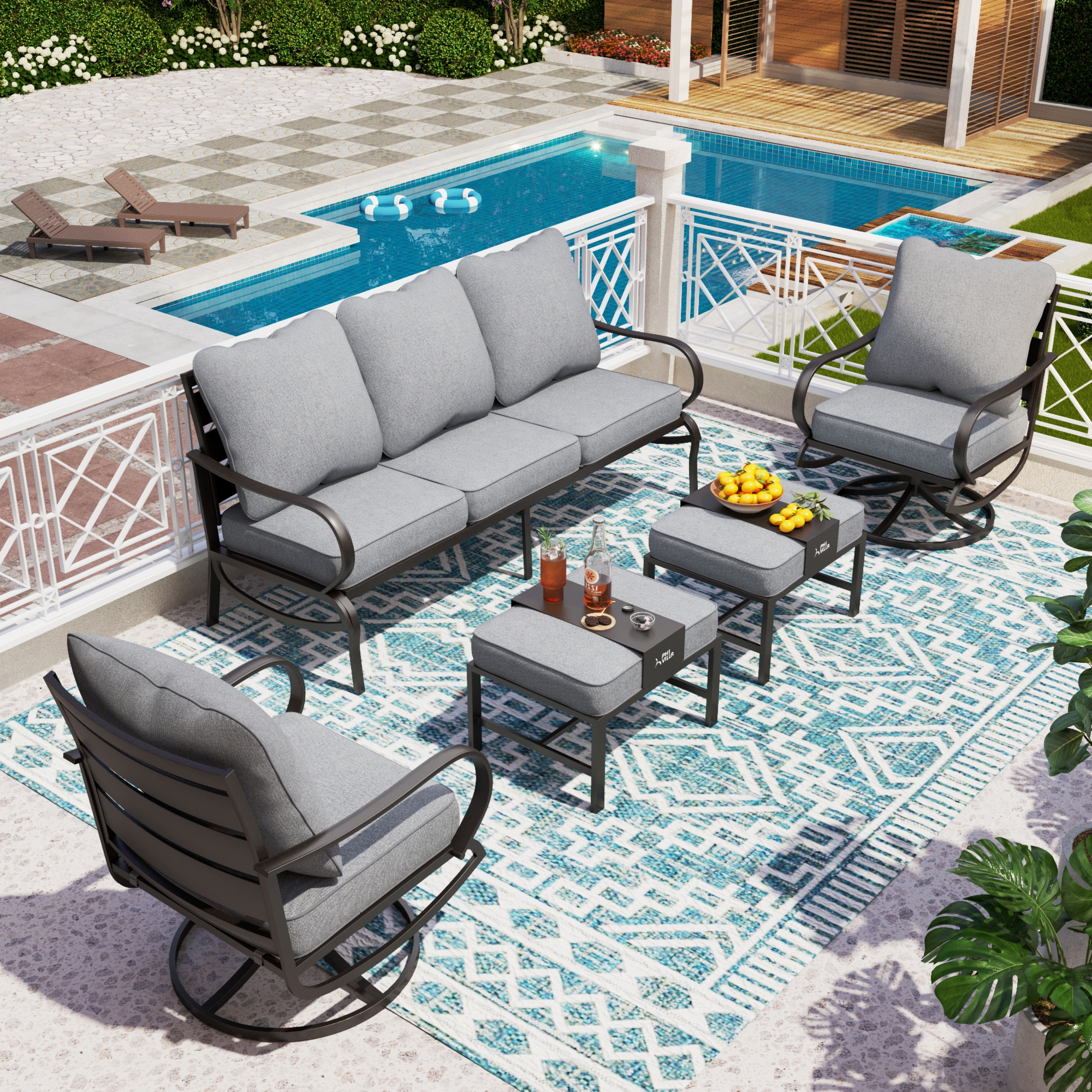 Outdoor patio furniture set including a sofa, two rocking chairs, and two square tables with cushions on a patterned rug.