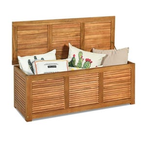 A wooden outdoor storage box with a slatted design, featuring a lift-up lid and hinged sides filled with decorative cushions.