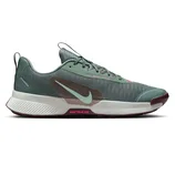 Nike Trail running shoe with a green mesh upper, white midsole, and maroon outsole, featuring a light blue Nike swoosh and \“Nike Trail ATC\“ branding in pink.