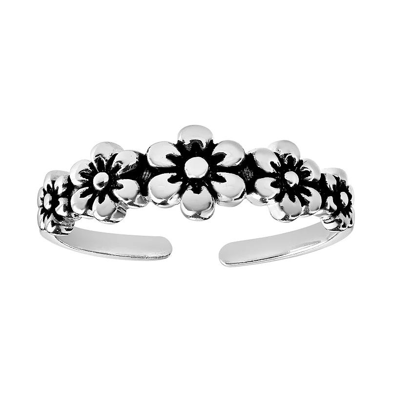 A silver ring featuring a floral design with a series of connected flowers in an open, adjustable band style.