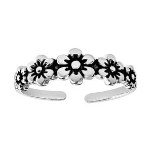 A silver ring featuring a floral design with a series of connected flowers in an open, adjustable band style.
