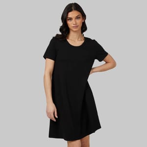 A woman wearing a short-sleeved black dress with a round neckline.