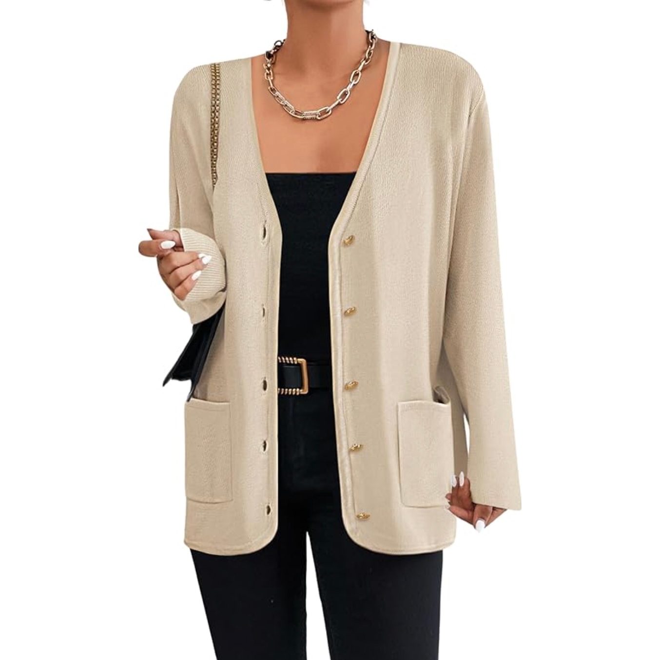 Beige long-sleeve cardigan with a V-neck, featuring button closures and two front pockets. Worn over a black top with a statement chain necklace, black belt, and coordinating pants.