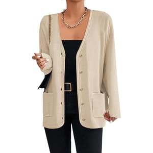 Beige long-sleeve cardigan with a V-neck, featuring button closures and two front pockets. Worn over a black top with a statement chain necklace, black belt, and coordinating pants.