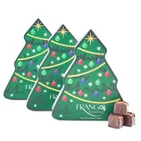 Three Christmas tree-shaped boxes decorated with ornaments and stars, labeled \“FRANGO Mint Chocolates,\“ alongside several unwrapped chocolate pieces.