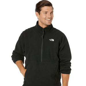 A man wearing a black zip-up fleece jacket with a small logo on the chest.
