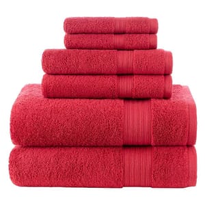 A stacked set of red towels in various sizes, including large bath towels at the bottom and smaller hand towels on top.