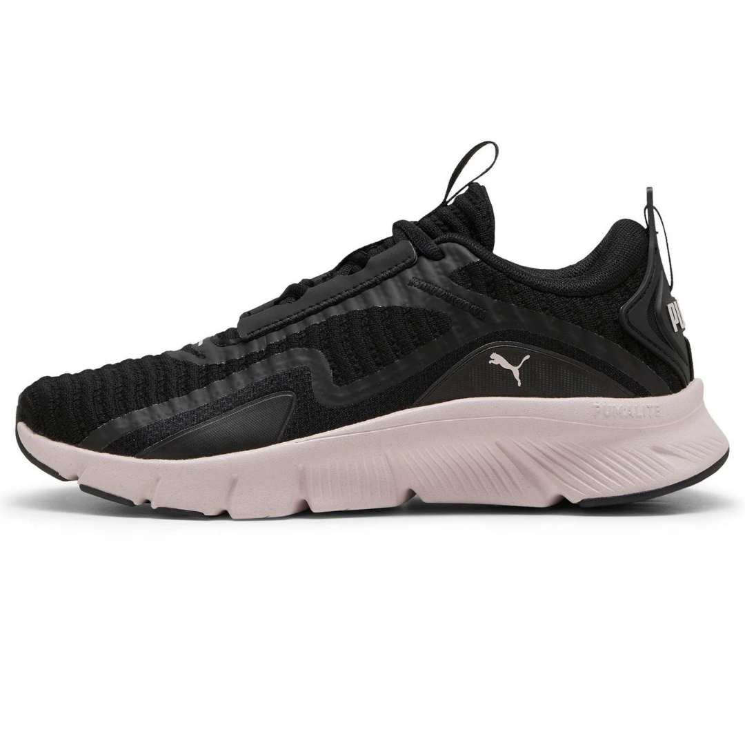Black and pale pink Puma Flexfocus sneakers feature a knit upper and a cushioned sole with the brand's logo on the side.