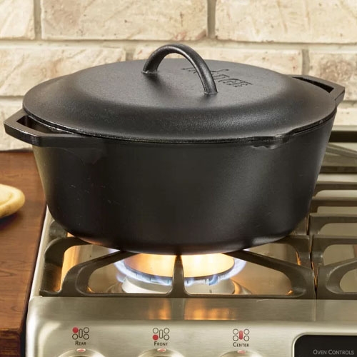 A black cast iron dutch oven on a stove top.