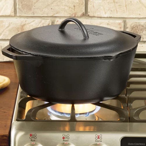 A black cast iron dutch oven on a stove top.