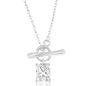 A toggle necklace featuring a rectangular, faceted crystal pendant on a slender chain, designed with a T-bar closure for easy wear.