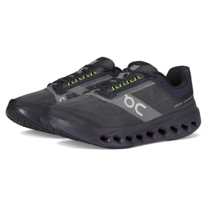 On Men's Cloudsurfer Next Shoes feature a sleek design in dark gray with neon green accents, a breathable mesh upper, the brand's signature cushioning technology with hollow pods for comfort, and \“Swiss Engineering\“ branding on the side.