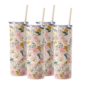 Set of four tall tumblers with floral designs featuring pink, yellow, and white flowers, each with a straw and clear lid.