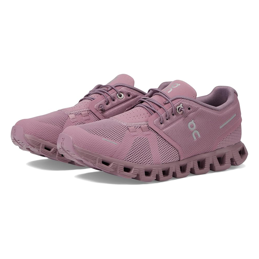 The On Cloud 5 Women's Shoes feature a sleek design in a dusty rose color, with a breathable mesh upper and signature CloudTec cushioning for comfort. They have lace-up closure and a durable sole designed for support and agility.