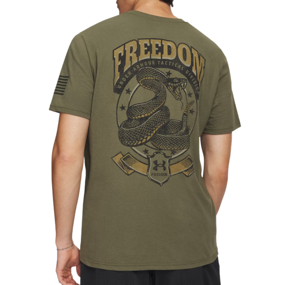 Olive green Under Armour T-shirt featuring a coiled snake graphic with \“FREEDOM\“ and \“UNDER ARMOUR TACTICAL DIVISION\“ text, and an arm patch design resembling the American flag.