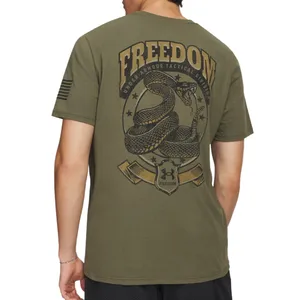 Olive green Under Armour T-shirt featuring a coiled snake graphic with \“FREEDOM\“ and \“UNDER ARMOUR TACTICAL DIVISION\“ text, and an arm patch design resembling the American flag.