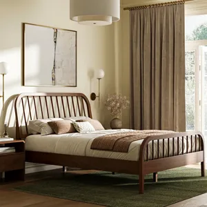 A bedroom features a wooden bed with a slatted head and footboard, dressed in neutral bedding. The room includes a modern chandelier, abstract wall art, matching wall sconces, beige curtains, a wooden nightstand, and a green area rug.