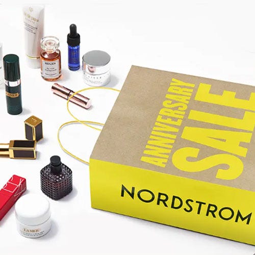 a nordstrom shopping bag displaying its spilled content of various beauty products