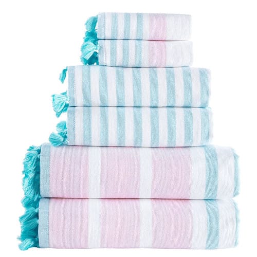 A stack of towels with blue and pink stripes and tassels.