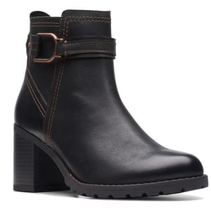 Black ankle boot with a block heel, strap, and buckle detail, featuring contrasting stitching.
