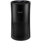A black Levoit air purifier with a cylindrical design, featuring a digital display on top and a perforated lower section for air intake.
