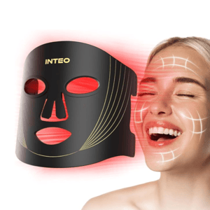 A black and gold LED face mask emits red light, likely used for skincare and anti-aging. A smiling woman's face is shown with overlayed lines suggesting areas of effect on her skin.