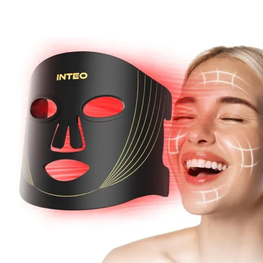 A black and gold LED face mask emits red light, likely used for skincare and anti-aging. A smiling woman's face is shown with overlayed lines suggesting areas of effect on her skin.
