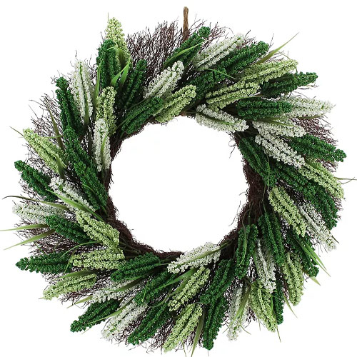 A decorative wreath featuring a mix of green and white artificial foliage arranged in a circular pattern.
