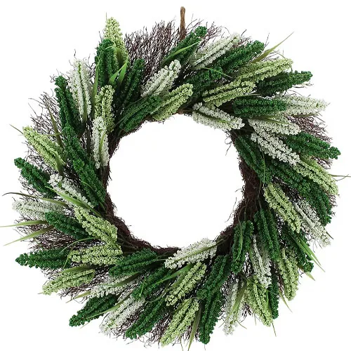 A decorative wreath featuring a mix of green and white artificial foliage arranged in a circular pattern.