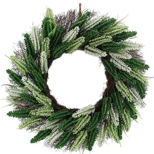 A decorative wreath featuring a mix of green and white artificial foliage arranged in a circular pattern.