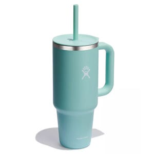 A turquoise mug with a handle and straw, featuring a Hydro Flask logo.
