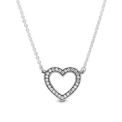 A silver necklace featuring a heart-shaped pendant with a double row of sparkling stones outlining the heart's shape, attached to a delicate chain.