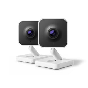 Two Roku Indoor Cameras with a sleek, modern design featuring a black front and a white adjustable base. They have a square shape with a prominent lens in the center.